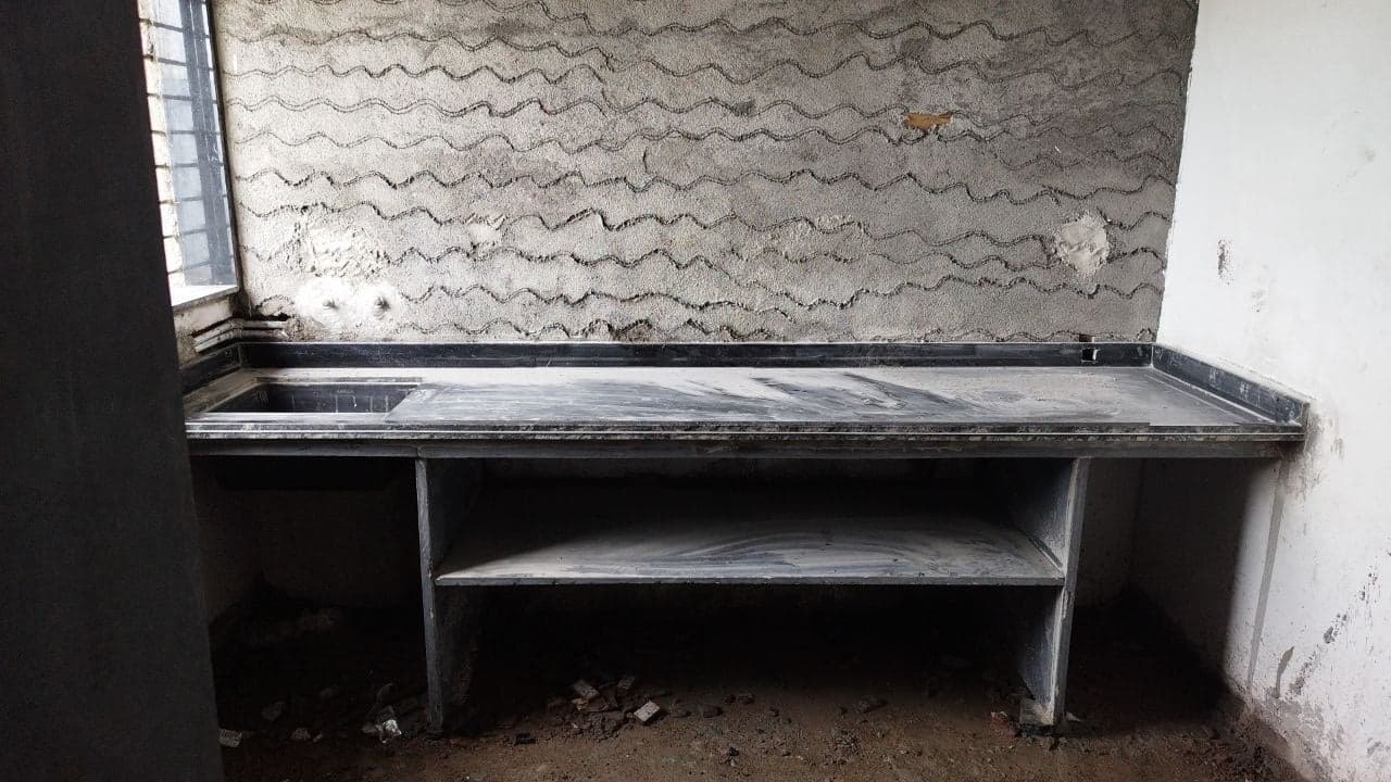 Straight granite kitchen platform with sink and storage shelf