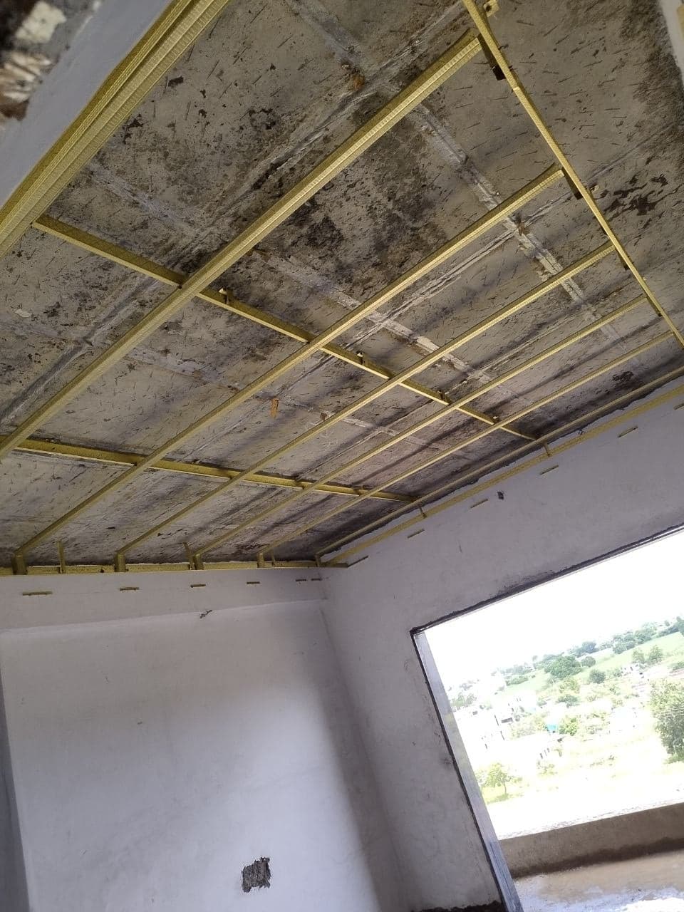 POP false-ceiling framework being installed in a room