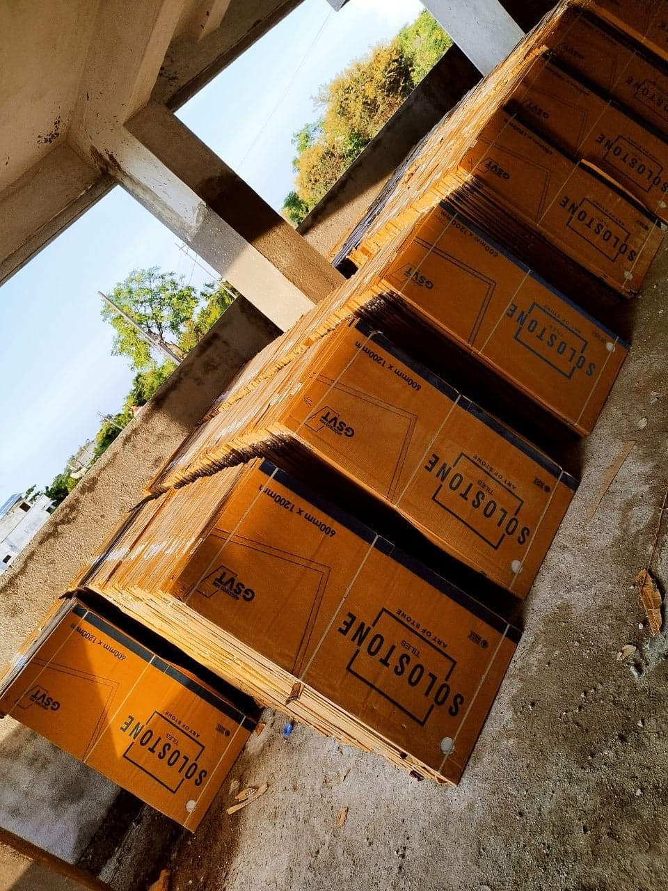 Tile boxes stacked on a floor ready for laying